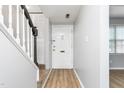 Inviting foyer featuring freshly painted gray walls, light wood flooring, and a staircase with black banister at 514 Peele St # A, Burlington, NC 27215