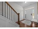 Inviting home entryway with wooden floors, staircase, wainscoting, and a bench for added convenience at 518 Hampton Crest Ct, Fuquay Varina, NC 27526