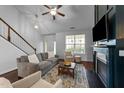Bright living room boasts a fireplace, comfortable seating, and large windows at 717 Maple Brook Rd, Fuquay Varina, NC 27526