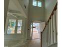 Bright foyer with soaring ceilings, staircase, and a view to the front yard at 789 Old Station Pointe, Angier, NC 27501