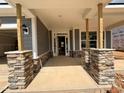 Inviting covered front porch with stone accents offering a warm welcome to the home at 789 Old Station Pointe, Angier, NC 27501