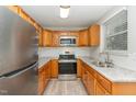 Updated kitchen featuring stainless steel appliances, granite countertops, and light wood cabinets at 820 Newcombe Rd, Raleigh, NC 27610