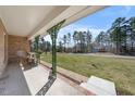 Inviting covered porch with decorative columns and a view of the front yard at 916 Clayton Rd, Durham, NC 27703