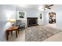 Cozy living room with a classic brick fireplace, neutral paint, and natural light at 916 Clayton Rd, Durham, NC 27703
