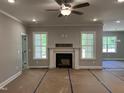 Spacious living room featuring a ceiling fan, neutral paint, a fireplace and large windows at 977 Lewis Rd, Zebulon, NC 27597