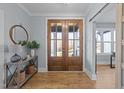 Entryway with wood floors, a console table with decor, and a view to an office at 110 Black Swan Dr, Youngsville, NC 27596