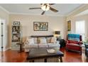 Bright living room with hardwood floors, neutral walls, plush seating, and elegant decor at 1104 Garnet Ridge Way, Raleigh, NC 27607