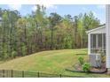 Spacious backyard with lush green lawn and tree-lined backdrop, perfect for outdoor activities and relaxation at 1131 Pate Farm Ln, Durham, NC 27703