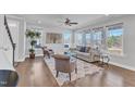 Inviting living room featuring hardwood floors, neutral paint and large windows providing ample natural light at 1160 Craigmeade Dr, Morrisville, NC 27560