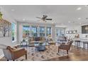 Bright living room featuring hardwood floors, a ceiling fan, and large windows offering natural light at 1160 Craigmeade Dr, Morrisville, NC 27560