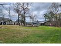 Expansive backyard with a large grassy area and mature trees, ideal for recreation and relaxation at 1209 Mill Valley Rd, Fuquay Varina, NC 27526