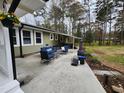 Covered patio boasting outdoor seating and a grill, perfect for entertaining at 1209 Mill Valley Rd, Fuquay Varina, NC 27526