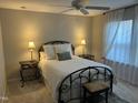 Cozy bedroom featuring a wrought iron bed frame, matching side tables, and bright natural light at 12409 Angel Vale Pl, Durham, NC 27703