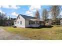 Exterior view of a quaint home with a screened-in porch and well-maintained lawn at 1721 Raleigh Rd, Henderson, NC 27536