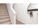 Bright entryway features luxury vinyl plank flooring and leads to carpeted stairs at 1802 Brim Dr, Haw River, NC 27258