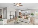 Cozy living room with hardwood flooring and neutral walls is open to the kitchen and dining room at 199 Pretty Run Branch Lane, Wendell, NC 27591
