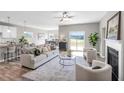 Spacious living room with fireplace, ceiling fan, and seamless access to the kitchen and dining area at 199 Pretty Run Branch Lane, Wendell, NC 27591