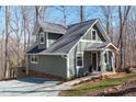 Charming cottage-style home featuring a covered front porch and well maintained lawn at 211 Fleming Dr, Durham, NC 27712