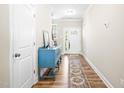 Bright entryway with hardwood floors and a decorative blue console table, with the front door in the background at 2177 Campbell, Burlington, NC 27215