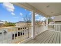 View from the balcony featuring white railings and grey wood flooring at 2310 Gilman St, Durham, NC 27703