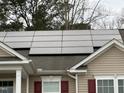 A close up view shows this homes solar panels mounted on the roof at 2310 Gilman St, Durham, NC 27703