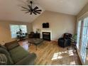 Inviting living room with hardwood floors, vaulted ceiling, fireplace, and natural light at 27 Creeks Edge Ct, Durham, NC 27713