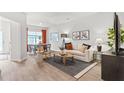 Bright living room with modern decor, wood flooring, and a comfortable seating area at 2836 Egert Dr, Haw River, NC 27258