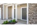 Townhome entrance featuring neutral siding, stone accents, and well-maintained landscaping at 2838 Egert Dr, Haw River, NC 27258