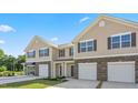Attractive townhome exteriors with driveways and modern entrances surrounded by fresh landscaping at 2838 Egert Dr, Haw River, NC 27258