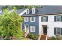 Charming townhouse with blue siding, dormer windows, and landscaped front yard at 3111 Coachmans Way, Durham, NC 27705
