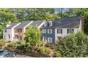 A row of townhomes with lush landscaping, showcasing the community's curb appeal and well-maintained surroundings at 3111 Coachmans Way, Durham, NC 27705