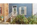 Inviting blue home entrance with brick accents and well-maintained landscaping at 3111 Coachmans Way, Durham, NC 27705
