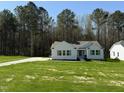 Charming single-story home featuring a well-manicured lawn and a concrete driveway at 325 Magnolia Run Way, Benson, NC 27504