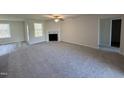 Spacious living room featuring a fireplace, windows, and carpet flooring at 325 Magnolia Run Way, Benson, NC 27504