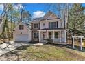 Inviting two-story home featuring stone accents, an attached garage, and an inviting front porch at 401 Newquay Ln, Wake Forest, NC 27587