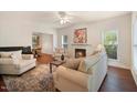 Bright living room with a fireplace, plush seating, large windows and neutral color palette at 4070 Landover Ln, Raleigh, NC 27616