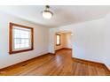 Bright dining room with gleaming hardwood floors, natural light, and arched doorway at 412 Suburb St, Rocky Mount, NC 27801
