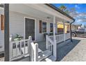 Inviting covered front porch features white railings, seating, and house number 43 at 43 Nordan St, Angier, NC 27501
