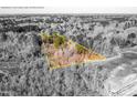 Aerial view of the property outlined in yellow, showing wooded area and natural landscape at 4324 Old Lewis Farm Rd, Raleigh, NC 27604
