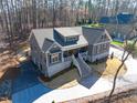 Aerial view of a gray home showing the roofline, landscaping and driveway approach to the charming two-story house at 4721 Cypress Ford Dr, Fuquay Varina, NC 27526