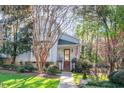 Charming two-story home with a well-manicured lawn, mature trees, and an inviting front porch at 515 Swim & Croquet, Pittsboro, NC 27312
