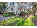 Beautiful home with manicured lawn, garden beds, and a cozy front porch at 515 Swim & Croquet, Pittsboro, NC 27312