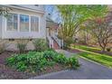 Quaint home featuring a landscaped yard, walkway, and inviting entrance at 515 Swim & Croquet, Pittsboro, NC 27312