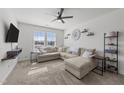 Bright living room with plush carpeting, a ceiling fan, and a large sectional sofa for relaxing at 6205 Taylor Rd, Wendell, NC 27591