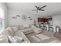 Open-concept living room featuring a ceiling fan, modern decor, and seamless flow into the kitchen at 6205 Taylor Rd, Wendell, NC 27591