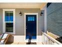 Inviting front entrance with a navy blue door, stylish sconces, and a window at 630 Great Ridge Pkwy, Chapel Hill, NC 27516