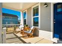 Cozy front porch featuring comfortable rocking chairs and ample natural light at 630 Great Ridge Pkwy, Chapel Hill, NC 27516