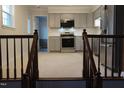 Modern kitchen with stainless steel appliances and gray cabinets at 6600 Coach Light Cir, Raleigh, NC 27613