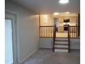 Open living room featuring stairs leading up to the kitchen at 6600 Coach Light Cir, Raleigh, NC 27613