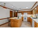 Cozy kitchen offering wood cabinetry, a center island, and essential appliances at 8429 Bells Lake Rd, Apex, NC 27539